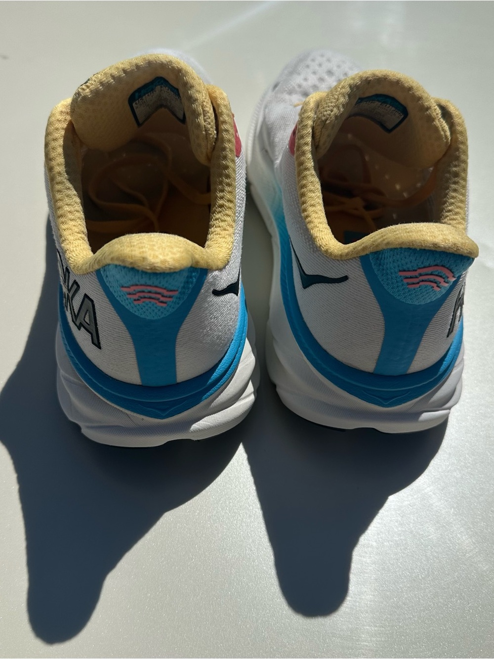 Hoka White Running Shoes with Yellow, Blue & Pink Accents - Picture 3 of 6